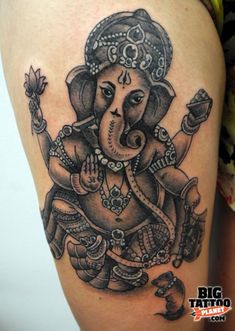 an elephant tattoo on the leg of a woman's thigh, showing it's head