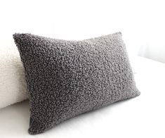 two pillows sitting next to each other on a bed