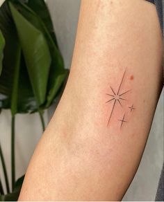 a small star tattoo on the arm