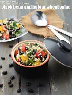 black bean and bulgar wheat salad in a bowl with spoons on the side