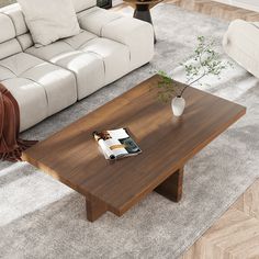 a living room with white couches and a wooden coffee table in the center area