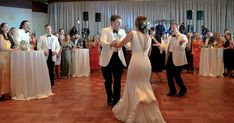 a bride and groom dancing on the dance floor in front of their guests at a wedding