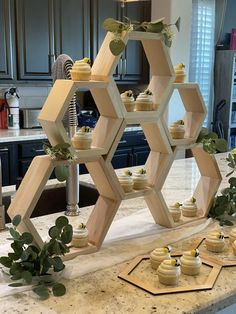 cupcakes are arranged in the shape of hexagons on a kitchen counter