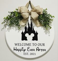 a mickey mouse door hanger that says welcome to our happily ever after