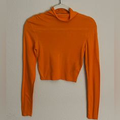 An Orange, Long-Sleeved, Turtle Neck Crop Top; Runched Design Across Both Shoulders, Runs Smaller; Never Worn Orange Stretch Long Sleeve Sweater, Orange Long Sleeve Stretch Sweater, Zara Long Sleeve Solid Sweater, Zara Long Sleeve Black Sweater, Orange Winter Tops For Work, Orange Winter Workwear Tops, Spring Stretch Turtleneck Blouse, Orange Tops For Winter Layering, Orange Tops For Workwear In Fall