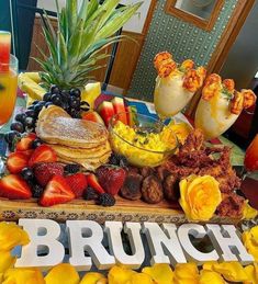 a brunch platter with fruit, pancakes and other foods