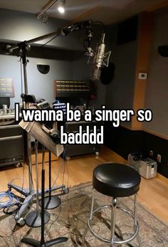 a recording studio with microphones and stools