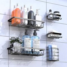 three metal shelfs with soap, shampoo and lotion bottles on them against a white tiled wall