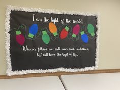 a bulletin board with christmas lights on it