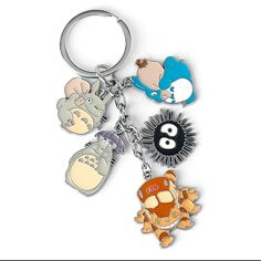 an assortment of cartoon key chains on a white background