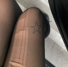 a woman's legs with a small star tattoo on her left leg and the bottom part of her thigh