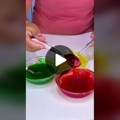 someone is mixing different colored paints in small bowls