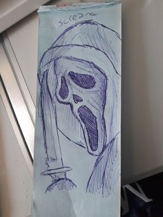 a paper bag with a drawing of a skull on it's side and a knife sticking out of its mouth