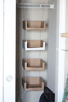 an open closet with hanging boxes on the wall