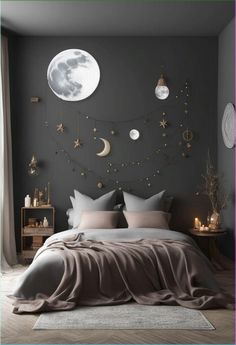 a bedroom with grey walls and gold stars on the wall, moon decorations above the bed