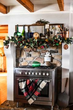 an old fashioned stove is decorated for christmas