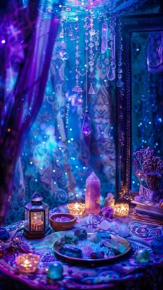 a table topped with plates covered in purple and blue lights next to a mirror filled with candles