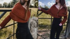 a woman wearing an orange sweater and black pants standing in front of a fence with her hands on her hips