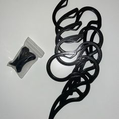 a pair of scissors sitting on top of a table next to a package of hair clips