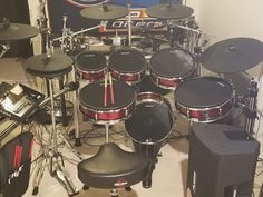 a bunch of drums that are sitting in front of some speakers and other musical equipment