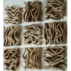 several pieces of wood that have been cut into squares and arranged in the shape of wavy lines