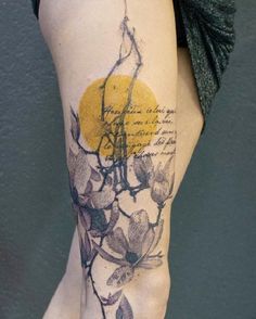 a woman's leg with flowers and writing on the side of her body,