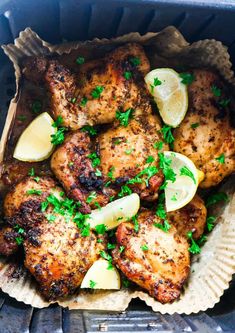 chicken with lemons and parsley in a paper plate