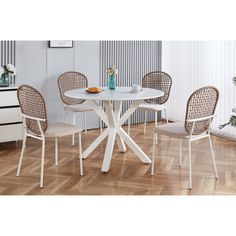 a white table with four chairs around it