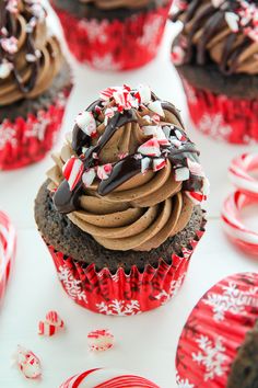 cupcakes with chocolate frosting and candy canes