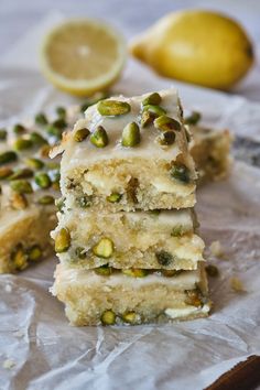 three pieces of cake sitting on top of a piece of wax paper next to lemons