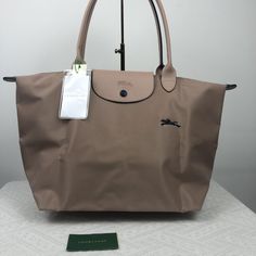 "Simple And Stunning Longchamp Le Pliage Club Tote Large Size In Gorgeous Hawthorn, Stunning Color Between Beige And Pale Pink, One Of My Fav Colors From This Collection One Of The Most Popular Colors In Le Pliage Bags Always Get Sold Out Quickly Double Handles Zip And Snap Closure; Unlined Interior Slip Pocket Foldable Design 12""W X 7.5""D X 11""H; 9"" Hand Drop Nylon, Trim: Cowhide Leather" Longchamp Le Pliage Mini, Longchamp Le Pliage Club, Longchamp Tote Bag, Polka Dot Tote Bag, Brown Leather Tote Bag, Suede Tote Bag, Brown Tote Bag, Blue Tote Bag, Nylon Handbag