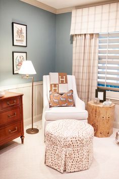 a chair and ottoman in a room with blue walls