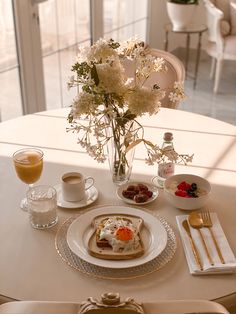 a table set for two with flowers and food