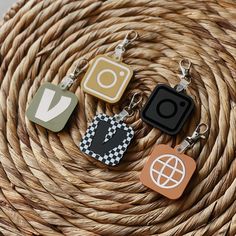 four different key chains sitting on top of a wicker basket