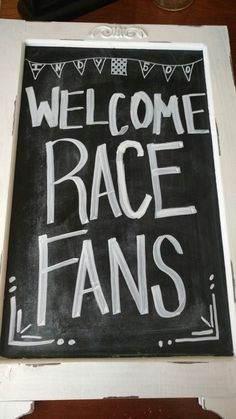 a sign that says welcome race fans on it