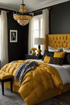 a bedroom with black walls, yellow bedding and chandelier hanging from the ceiling