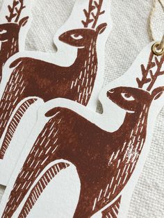 two brown and white deer stickers hanging from strings