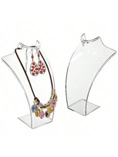 two clear acrylic jewelry stands with necklaces and earring holders on them