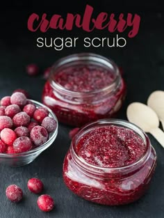 cranberry sugar scrub in small glass bowls with spoons next to it on a black surface