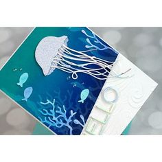 a close up of a card with a jellyfish on it