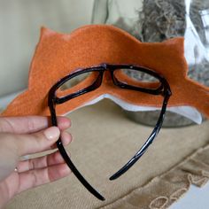 a person holding up a fake mask with glasses on it