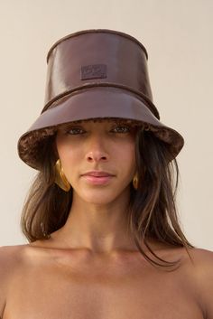 A fur trimmed patent leather reversible bucket hat. — Patent leather — Fur lined — Reversible Reversible Bucket Hat, Cult Gaia, Lifestyle Brand, Fur Trim, Clothing For Women, Lifestyle Brands, Java, The Fall, Patent Leather