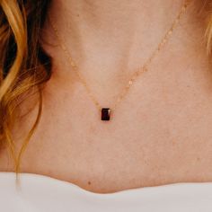 Our dainty Garnet Necklace is part of our new Birthstone Necklace Collection! This beautiful, yet delicate necklace is made with top-quality, genuine Garnet. The January birthstone represents success + loyalty. The Garnet stone is emerald cut and faceted to ensure it sparkles from every angle. This beauty is perfect to gift to someone special, or treat yourself! It deserves to be worn every day. ---------------------- FEATURES ◊ Genuine Garnet stone (measures 7mm x 9mm) ◊ Choice of yellow gold f Dainty Jewelry Necklace, January Birthstone Necklace, Baguette Diamond Necklace, Baguette Necklace, Garnet Birthstone, Gemstone Pendants, Silver Necklace Statement, Necklace Collection, Ruby Pendant