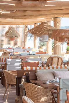 an outdoor dining area with wicker chairs and tables