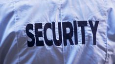 the word security is written on a white jacket with black letters that spell out it