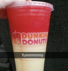 a dunkin donuts drink is being held by someone