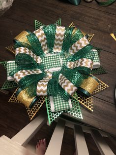 a green and white bow sitting on top of a wooden table