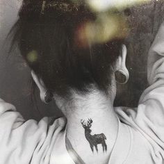 a woman with a deer tattoo on her neck