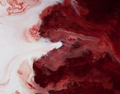 red and white paint swirls in the center of an abstract painting with black spots on it