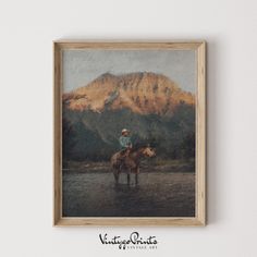 an oil painting of a man riding a horse in front of a mountain range with trees